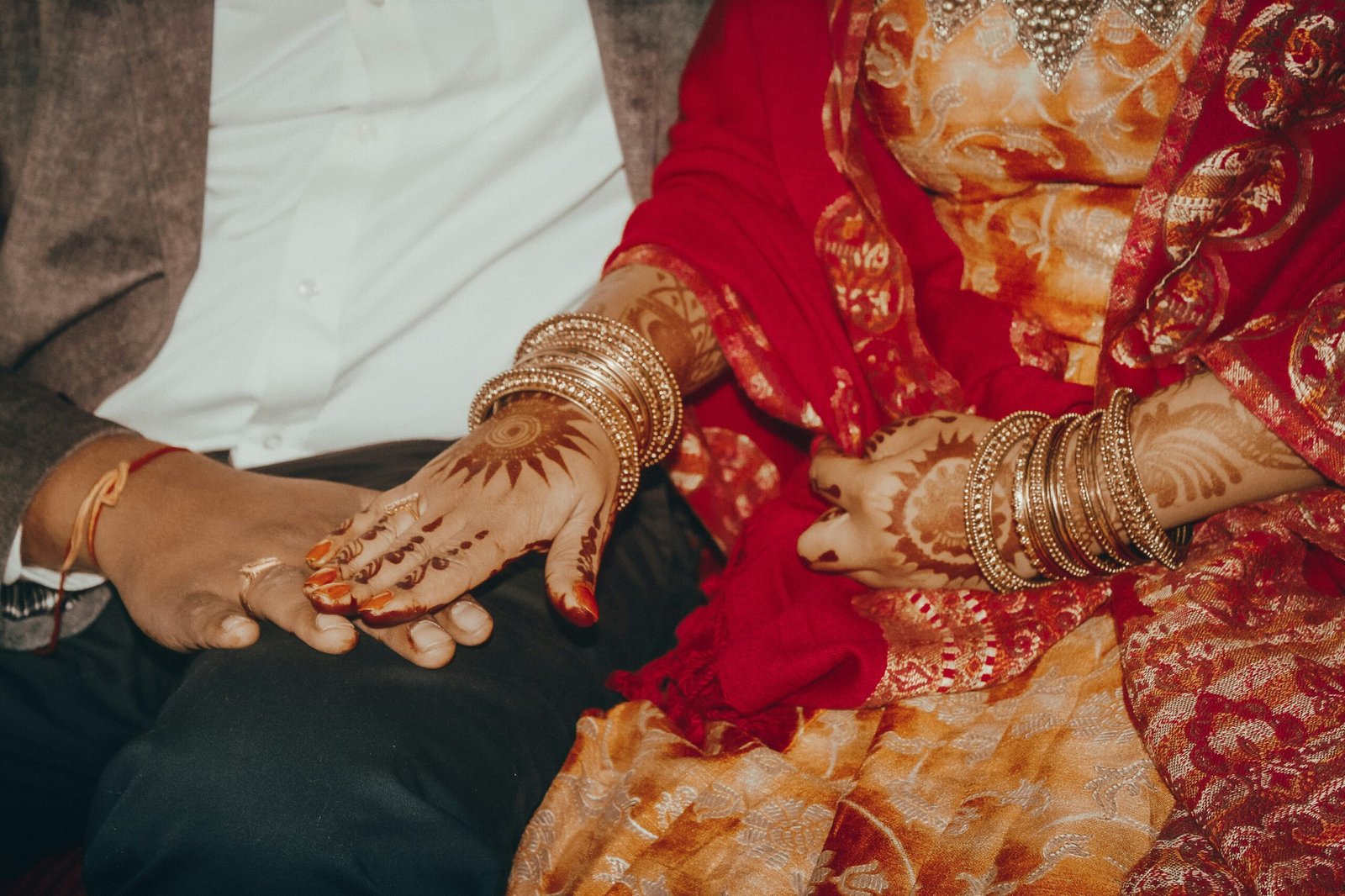 a close up of two people holding hands